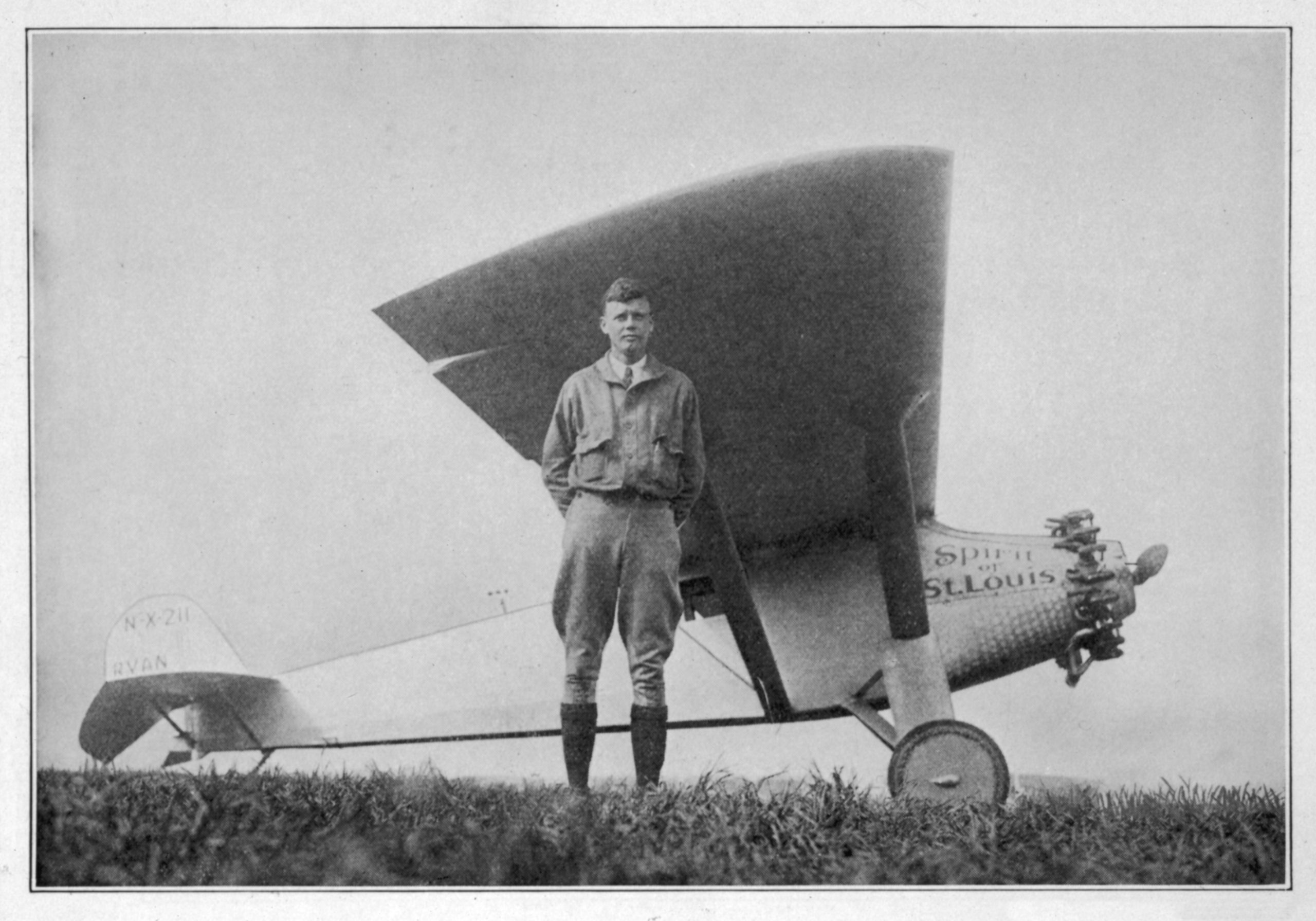 Charles Lindbergh standing beside the Spirit of St. Louis aircraft before his historic 1927 flight from Roosevelt Field on Long Island.