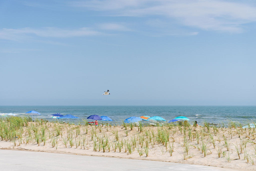 TOBAY Beach in Nassau County with sand dunes, beach umbrellas, and Atlantic Ocean views on a summer day.